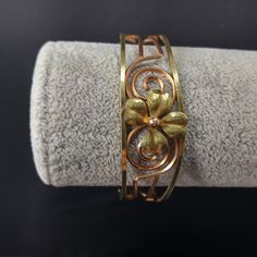 *Description: This is a beautiful 14 K rolled gold overlay Krementz cuff bracelet featuring a gold four leaf clover in the center. The open work makes the bracelet light on your wrist. On the end of each side of the cuff is the KREMENTZ stamp. I acid tested the surface of the bracelet which tested at 14K gold. The inside is a magnetic unknown metal. The bracelet is six inches around the inside with 3/4 of an inch gap. This cuff bracelet would be a great gift or wonderful addition to your vintage Vintage Yellow Gold Bangle For Gift, Vintage Yellow Gold Bangle Gift, Vintage 14k Stamped Gold Bangle, Vintage Yellow Gold Bangle Cuff Bracelet, Vintage 14k Gold Bangle, Antique Yellow Gold Hallmarked Cuff Bracelet, Victorian Gold Bangle Cuff Bracelet, Vintage Yellow Gold Hallmarked Cuff Bracelet, Antique Hallmarked Yellow Gold Cuff Bracelet