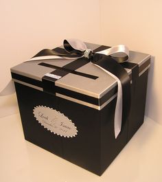 a black and white box with a ribbon on it