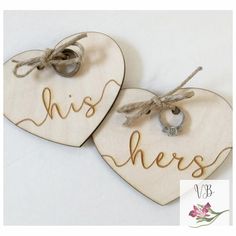 two wooden hearts with the words his and hers written on them