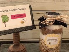 a jar filled with lots of food next to a sign that says butterscotch bee oatmeal