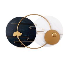 two circular wall hangings with marble and gold accents on the sides, one in black and one in white