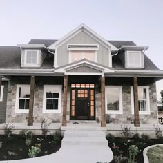 a large house with stone and wood accents