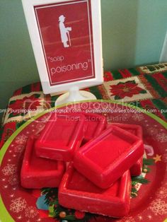 soap bars on a red plate with a sign in the background that says soap possoning