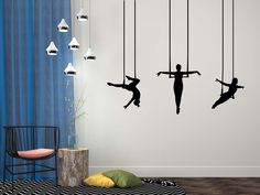 the silhouettes of three people hanging on strings are shown in this modern living room