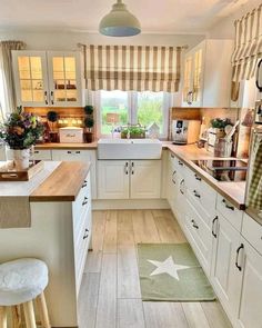 a kitchen with wooden floors and white cabinets