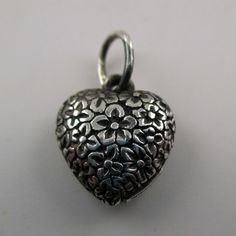 "This sterling silver, two-sided Solid Puffy Heart Charm Number 75 (Floral Heart) features a repeating design of flowers.Marked, Sterling. Made by Brown County Silver. Vintage and in new, never worn condition. Approximately 30 years old. Available in sterling silver and sterling silver with 14k gold vermeil. 3/4\" high with jump ring. 1/2\" wide 2.4 grams approx. *Chain not included See more @ https://www.etsy.com/shop/brocosi" Silver Spiritual Heart Charm Necklace, Silver Open Heart Necklace With Charms, Silver Heart Necklace With Heart Beads, Handmade Silver Double Heart Necklace, Handmade Silver Heart Necklace, Brown County, Puffy Heart Charms, Hearts Valentines, Sterling Silver Charms