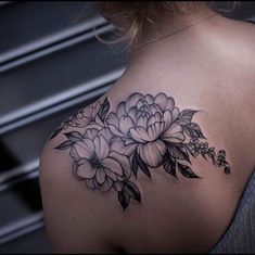 a woman with a flower tattoo on her shoulder