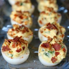 bacon and cheese deviled eggs on a glass platter