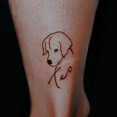 a small dog tattoo on the leg