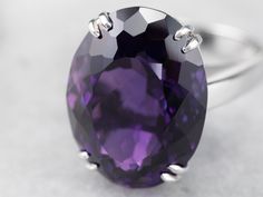 This exceptional amethyst commands attention! Generous in size, this gemstone sparkles with juicy hues of violet, fuchsia, and royal purple. A simple setting of 18 karat white gold lets the amethyst be the star of the show. Metal: 18K White Gold Gem: Amethyst 12.20 Carats Gem Measurements: 12.9 x 16.9 mm, Oval Ring Size: 6.25 Marks: "750" Stamped on the inside band Elegant Purple Gemstones For Formal Occasions, Timeless Purple Jewelry For Formal Occasions, Elegant Amethyst Ring For Formal Occasions, Elegant Amethyst Gemstones For Formal Occasions, Formal Purple 14k White Gold Rings, Purple Elegant Gemstones For Formal Occasions, Elegant Silver Amethyst Ring With Diamond Cut, Formal Amethyst Ring In White Gold Platinum, Formal Amethyst Gemstones In White Gold