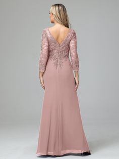 a woman in a long pink dress with an open back and lace detailing on it