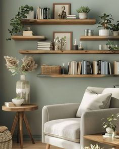 a living room filled with furniture and lots of books on the shelf above it's head