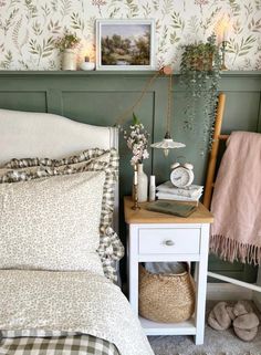 a white bed sitting next to a green wall