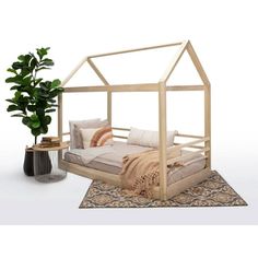 a bed sitting on top of a rug next to a potted plant