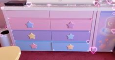 a pink and blue dresser with stars on it