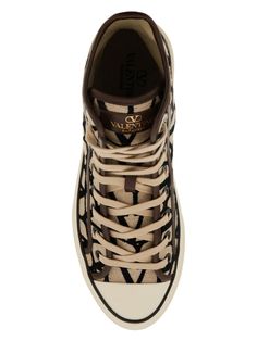 Step up your sneaker game with these high-top sneakers by Valentino Garavani. Made of toile iconographe with leather details and featuring a gold-tone logo print on the tongue, these sneakers are the perfect blend of style and comfort. With a fabric lining, removable insole, and rubber sole featuring an embossed monogram pattern, these high-tops are the ultimate statement piece for any fashion-forward individual. Plus, they come with spare laces for added versatility. Fabric lining Removable ins Hermes Birkin 25, Versace Bags, Monogram Pattern, Birkin 25, Prada Designer, Sneaker Games, Fendi Bags, Casual Backpack, Prada Bag