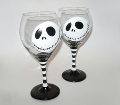 two wine glasses with faces painted on them