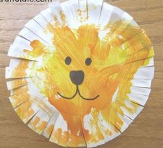 a paper plate with a lion face painted on it