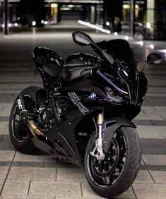 a black motorcycle parked on the street at night