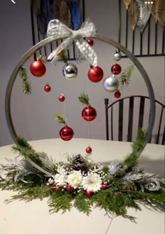 a table topped with ornaments and greenery