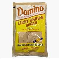 a bag of light brown sugar on a white background with the words domino in it