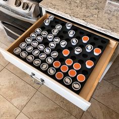 an open drawer in the middle of a kitchen