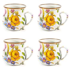 four coffee cups with flowers painted on them