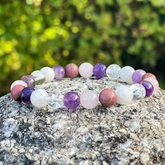 The Grief and Loss Bracelet helps to ease grief and healing from loss. When going through the grieving process, it is important to practice self-care. This bracelet is a beautiful and easy way to do that. It includes gemstones that can help soothe emotions and clear your mind and help you feel at peace during this difficult time. The gemstones include Amethyst for inner peace, Rose Quartz for love and compassion, Rhodonite for emotional energy healing and inner Peace, Lepidolite a stone known fo Spiritual Lavender Bracelets With Natural Stones, Healing Rose Quartz Bracelets With Natural Stones, Healing Rose Quartz Gemstone Bracelets, Healing Rose Quartz Natural Stones Bracelet, Lavender Natural Stones Spiritual Bracelet, Spiritual Lavender Crystal Bracelet For Meditation, Spiritual Rose Quartz Crystal Bracelet For Healing, Healing Rose Quartz Bracelets, Healing Lavender Crystal Bracelet With Gemstones