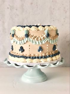 a three tiered cake with blue and white icing