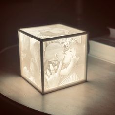 a cube shaped light box with an image of a baby on it