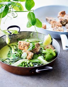 a pan filled with green vegetables and meat