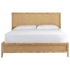 an image of a bed that is made up with wicker and white linens