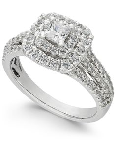 a white gold ring with two rows of diamonds on the band and a square shaped center stone