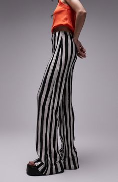 Bold stripes draw attention to these wide-leg trousers that add instant style points to in-office or off-duty looks. 100% polyester Machine wash, line dry Made in the UK Chic Wide Leg Bottoms With Vertical Stripes, Elegant Striped Bottoms For Night Out, Chic White Wide Leg Pants With Vertical Stripes, Chic Striped Full-length Bottoms, Striped Full-length Bottoms For Work, Chic Full Length Striped Bottoms, Elegant Wide Leg Pants With Vertical Stripes, Elegant Wide Leg Trousers With Vertical Stripes, Elegant Spring Wide Leg Pants With Vertical Stripes