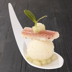 a white plate topped with food on top of a wooden table