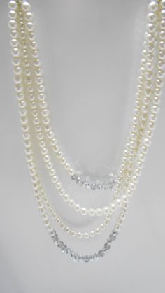 "Gorgeous vintage faux pearl necklace. Four strands of 8mm faux pearls & crystals. The end strands consist of two 6\" strands of rhinestone rondelles, silver tone bead spacers, various mm sizes of faux pearls and a crystal. The faux pearl graduating strands are 15\" - 21\" long. Lobster claw fastener. This is a very heavy necklace. Excellent condition. Unsigned." Formal Multi-strand Beaded Pearl Necklace, Elegant Beaded Rhinestone Necklace With Round Beads, Classic Multi-strand Pearl Necklace For Party, Formal Pearl Necklace With Rhinestones, Vintage Pearl Necklaces With Rhinestones, Formal Beaded Pearl Rhinestone Necklace, Heavy Necklace, Funky Necklace, Faux Pearl Necklace