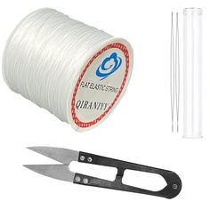 a spool of thread, scissors and wire on a white background