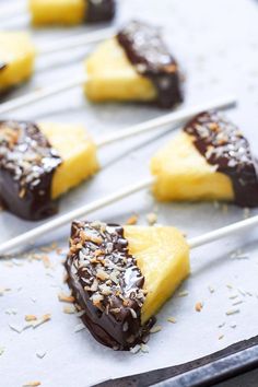 chocolate dipped pineapples are sitting on a baking sheet