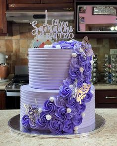 there is a purple cake with flowers on it