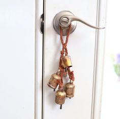 a door handle with bells attached to it