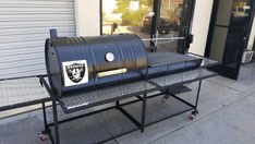 a bbq grill sitting on top of a metal rack outside of a store front