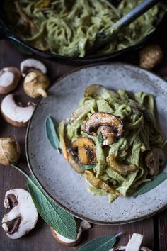 pasta with mushrooms and pesto sauce on a plate