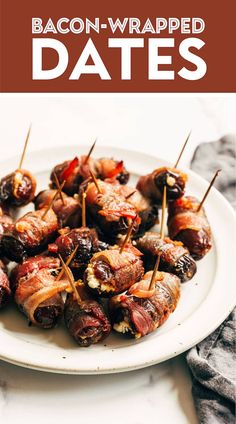 bacon wrapped dates on a white plate