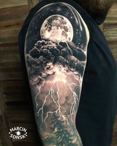 a man's arm with a full moon and lightning tattoo on the upper half of his arm