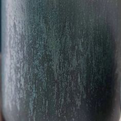 a close up view of the side of a green vase