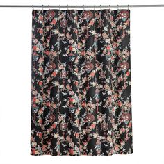 a black shower curtain with flowers and birds on it, hanging in front of a white wall