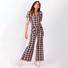 Super retro vintage 70s brown and white plaid flared leg jumpsuit with a zipper up the front, a pointed collar, and big pockets at the hips. A few minor condition notes, see details below. Measurements and Condition:  Fits like: Petite extra small Fabric: Feels like polyester Brand: None, appears to be handmade Condition: Very good, with a 1/3" red spot on the front right of the waist, a tiny section of minor fraying at the bottom of the zipper with a small snag next to it (see close up photo), Zip Up Outfit, 70s Plaid, Womens Jumpsuits, Big Pockets, Bell Bottom, White Plaid, Bell Bottoms, Vintage 70s, Jumpsuits For Women