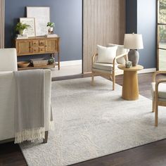 a living room with blue walls and white furniture