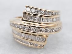 This unique double-row diamond bypass ring would make a beautiful wedding or anniversary band! Round and baguette-cut diamonds form a sparkling focal point of the ring, with additional diamond accents extending the glitter into the band. This ring is a fresh take on a timeless design!Metal: 14K Yellow GoldGem: 67 Diamonds totaling 1.09 Carats, I1 in Clarity, H in ColorWidth of Band: 16.4 mmHeight off Finger: 5.3 mmRing Size: 5.75Marks: “14K MMWA” Stamped on the inside band Diamond Gold Band, Yellow Gold Amethyst Ring, Channel Set Diamond Band, Wedding Band Diamond, Vintage Wedding Jewelry, Diamond Pendants Designs, Gold Amethyst Ring, Petite Earrings, Antique Jewelry Indian