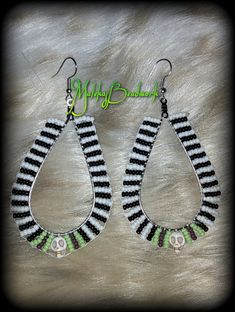 two pairs of earrings with black and white stripes